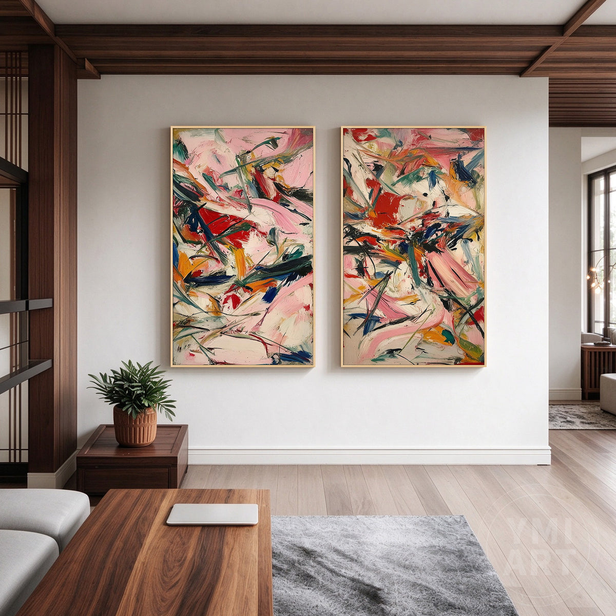 Colorful pink and red abstract diptych wall art shown with a light wood frame in a contemporary interior.