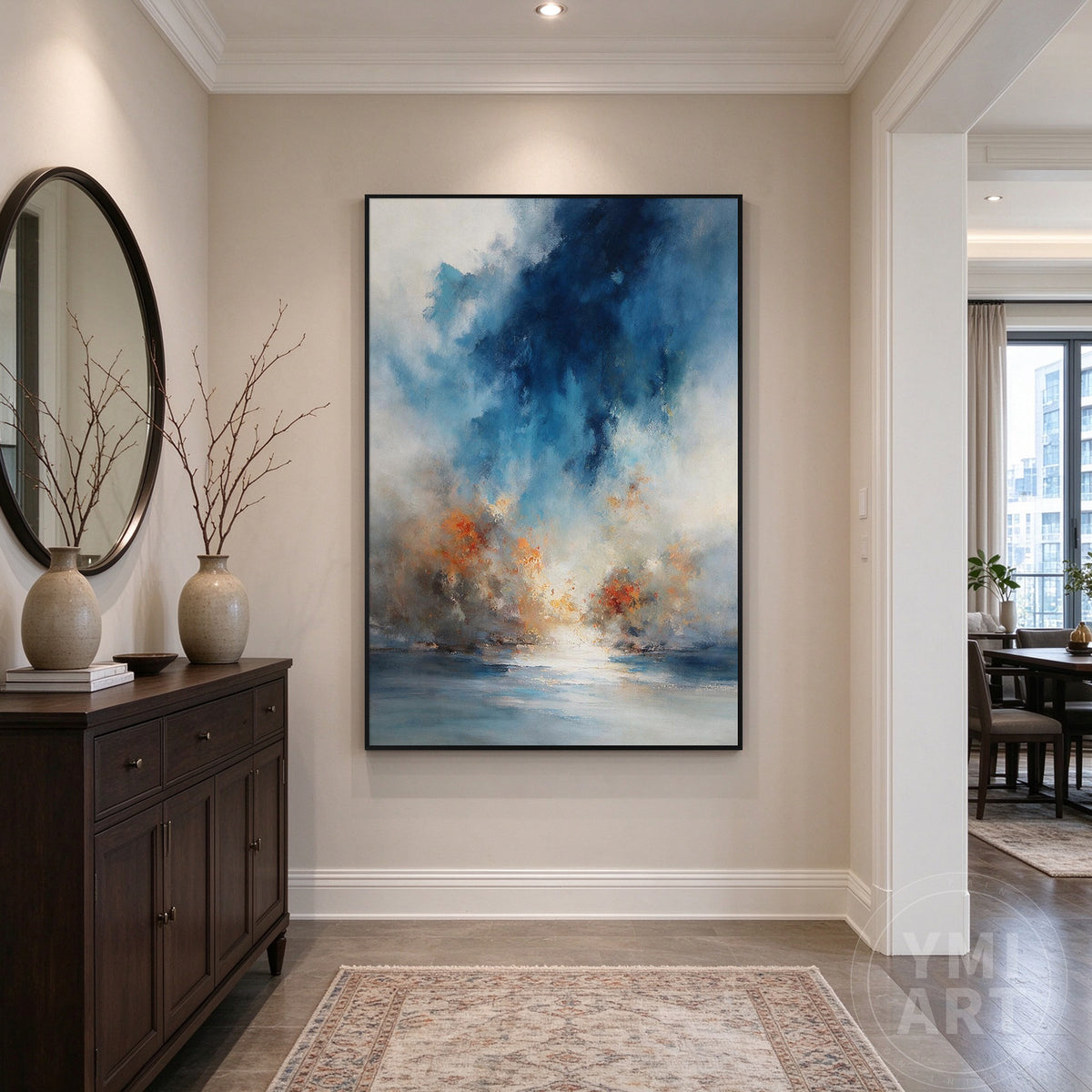 Vertical blue abstract wall art displayed above a dark wood console in an elegant neutral entryway.